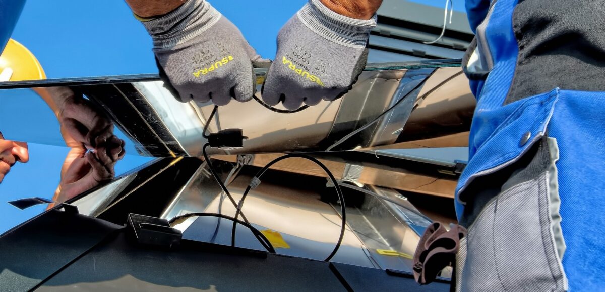 artisans en train de brancher des panneaux solaires en série ou parallèle