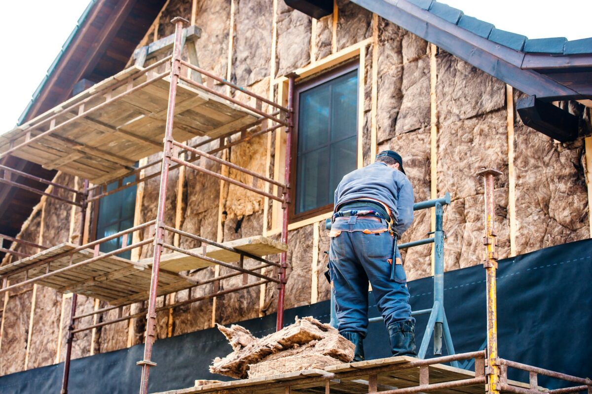 artisan isolant une maison avec de la laine de bois ou fibre de bois